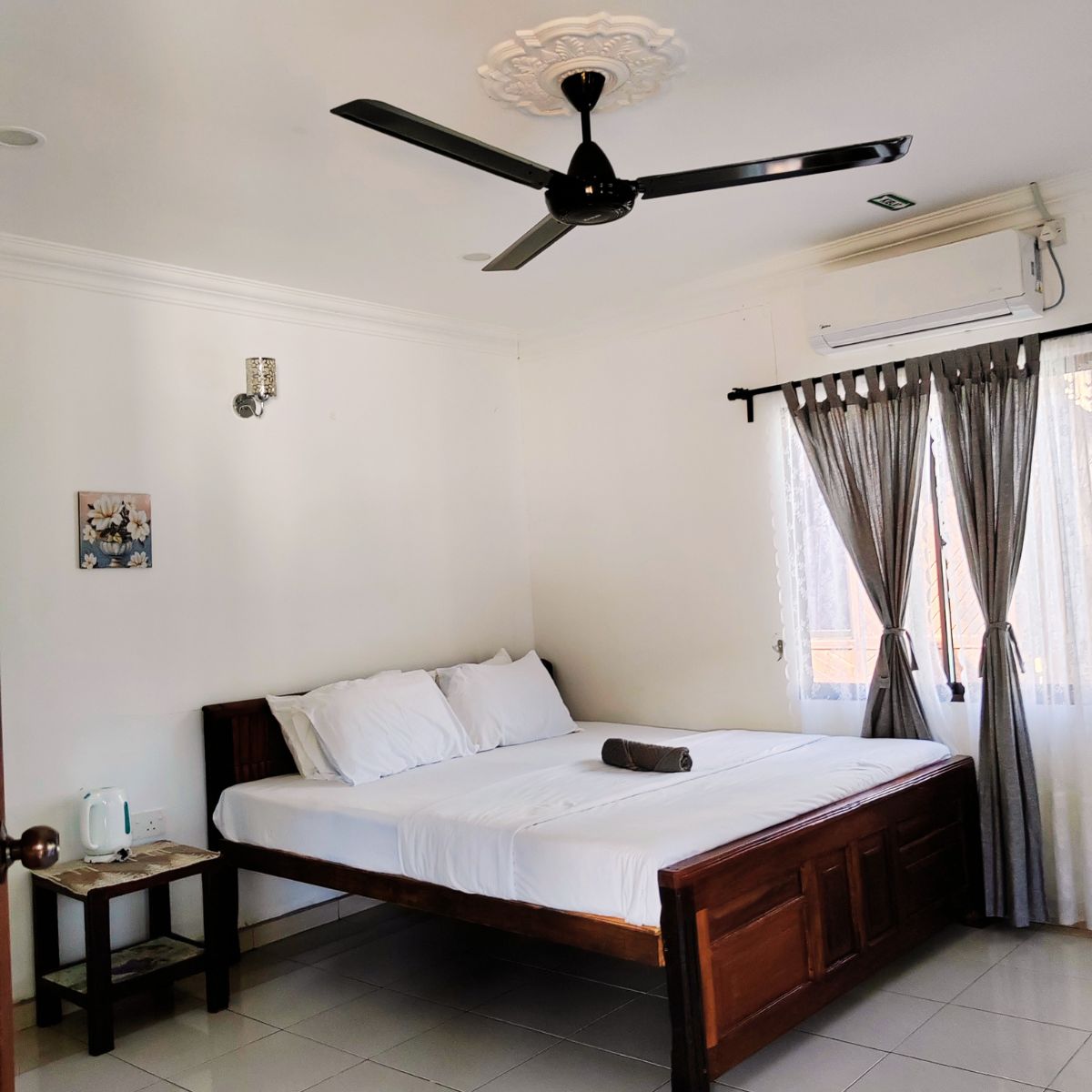 Guest room with fan and air conditioning at My River Village